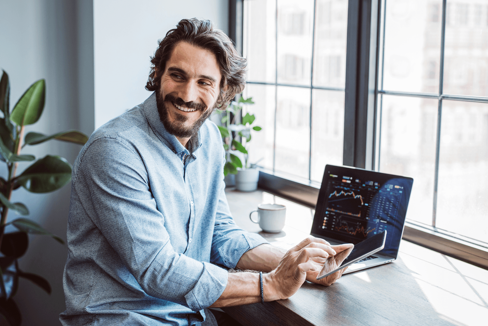 Image of a men working in the household with a laptop to representVolue Day-Ahead Bidding